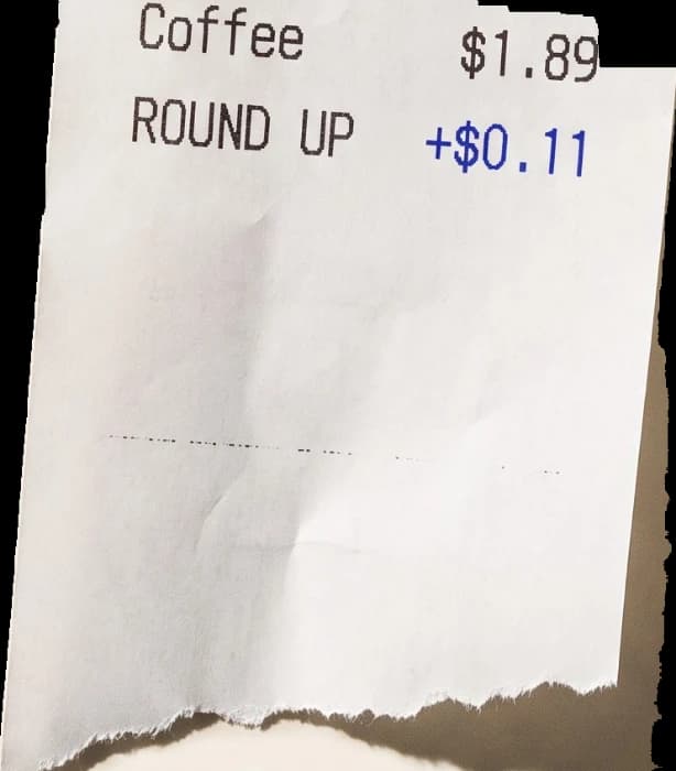 A torn thermal receipt printed Coffee $1.89, Round up $0.11, Total $2.00.